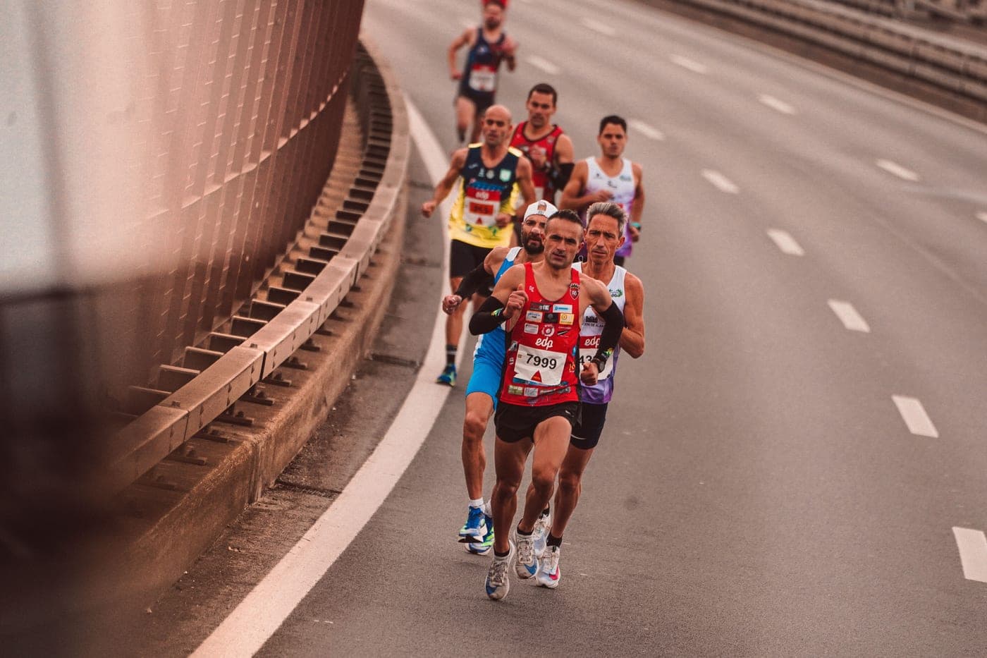 A group of marathon runners on a city road